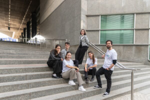 IVY volunteers in Brussels, sitting on a stair and smiling